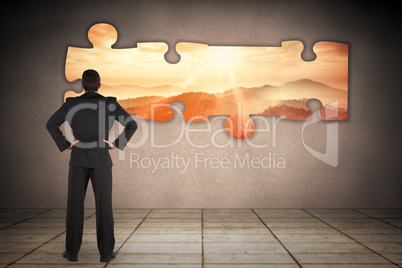 Composite image of businessman standing back to the camera with