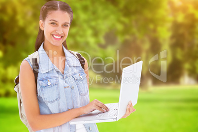 Composite image of student using laptop