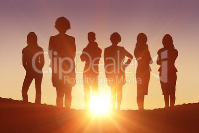 Composite image of standing silhouettes