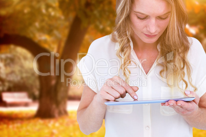 Composite image of woman using tablet pc