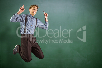 Composite image of geeky hipster jumping and pointing