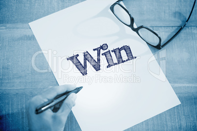 Win against left hand writing on white page on working desk