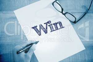 Win against left hand writing on white page on working desk