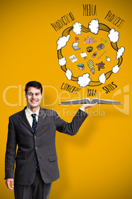 Composite image of businessman showing a book