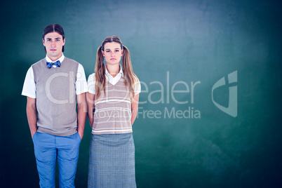 Composite image of unsmiling geeky hipsters looking at camera