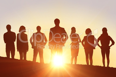 Composite image of silhouettes standing