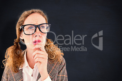 Composite image of geeky hipster woman thinking with hand on chi