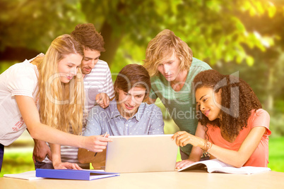 Composite image of college students using laptop in library