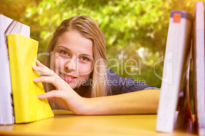 Composite image of pretty student in the library