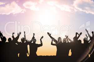 Composite image of silhouetters celebrating