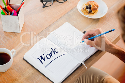 Work  against man writing notes on diary