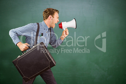 Composite image of geeky hipster shouting through megaphone