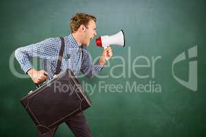 Composite image of geeky hipster shouting through megaphone