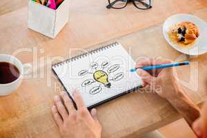 Composite image of man writing notes on notebook