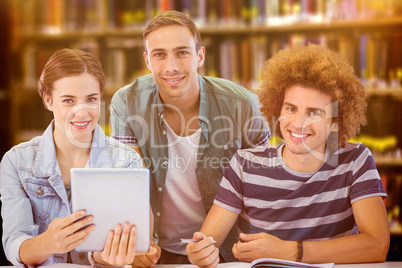 Composite image of fashion students using tablet