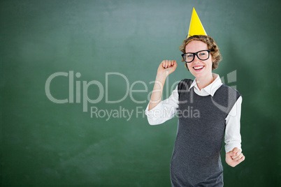 Composite image of geeky hipster wearing a party hat
