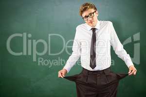 Composite image of geeky businessman showing his empty pockets