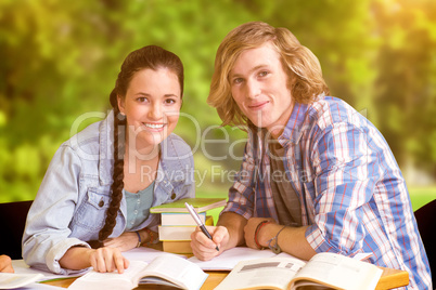 Composite image of college students doing homework in library