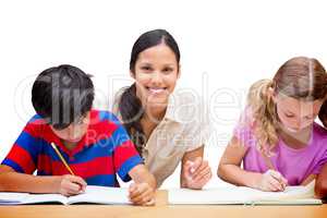 Composite image of pretty teacher helping pupils in library