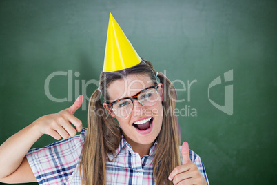 Composite image of geeky hipster smiling at camera thumbs up