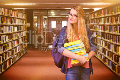 Composite image of pretty student in the library