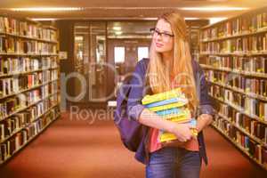 Composite image of pretty student in the library