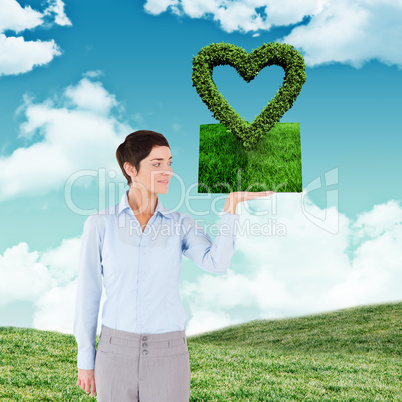 Composite image of woman holding lawn book