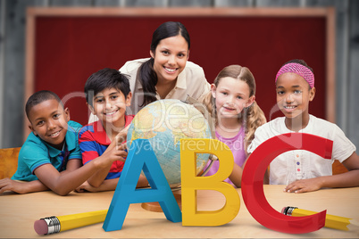 Composite image of cute pupils and teacher looking at globe in l