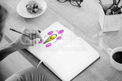 Composite image of man writing notes on diary