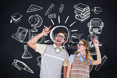 Composite image of happy geeky hipster couple pointing up