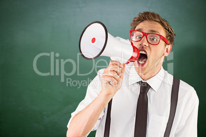 Composite image of geeky businessman shouting through megaphone