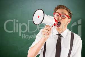 Composite image of geeky businessman shouting through megaphone