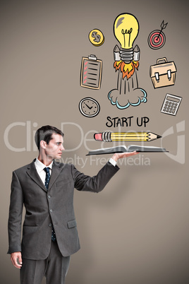 Composite image of businessman showing a book