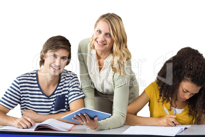 Composite image of teacher helping student in class