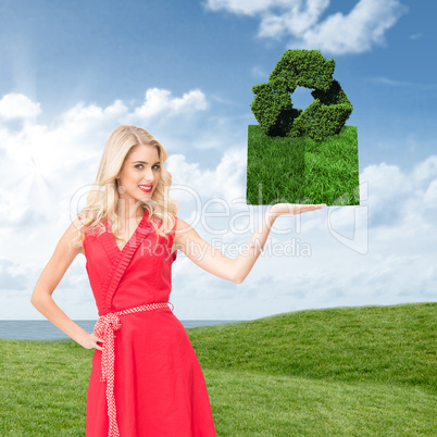 Composite image of woman holding lawn book