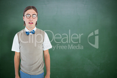 Composite image of geeky hipster looking at camera