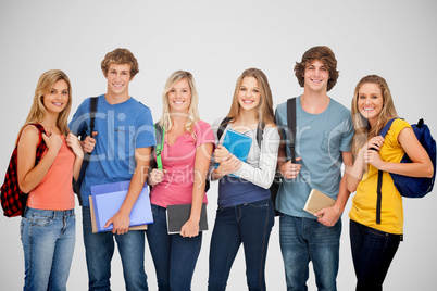Composite image of smiling students all geared up for college