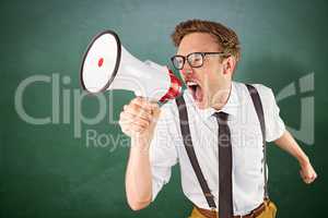 Composite image of geeky businessman shouting through megaphone