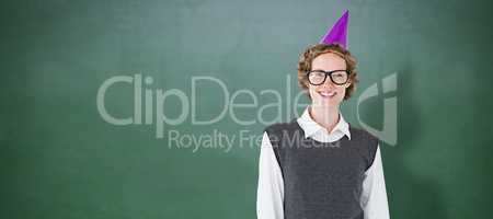Composite image of geeky hipster wearing a party hat