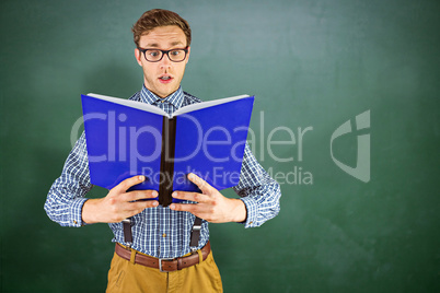 Composite image of geeky businessman reading a book