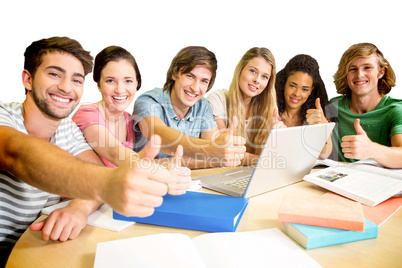 College students gesturing thumbs up in library