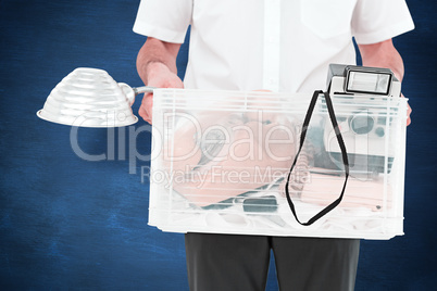 Composite image of businessman holding box of his things