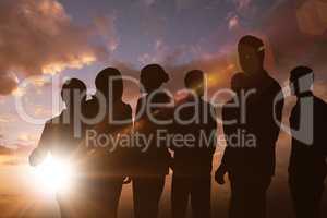 Composite image of silhouetters celebrating