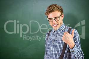 Composite image of geeky hipster showing thumbs up