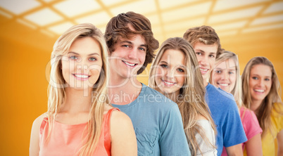 Composite image of a smiling group standing behind each other