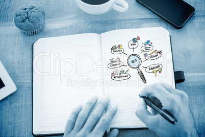 Composite image of man writing notes on diary