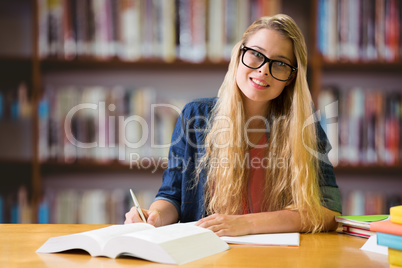 Composite image of student studying in the library