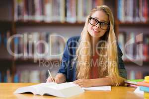 Composite image of student studying in the library