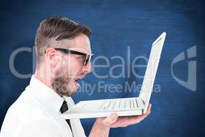 Composite image of geeky frustrated businessman looking at his laptop