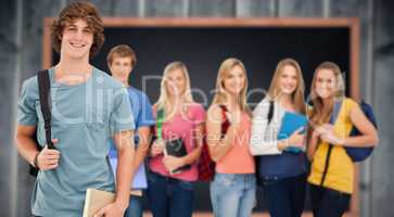 Composite image of a man standing in front of his friends as he